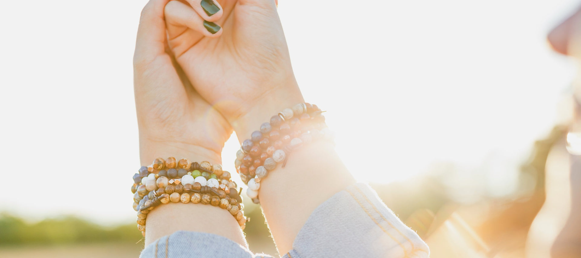 two arms embrace with bracelets on 