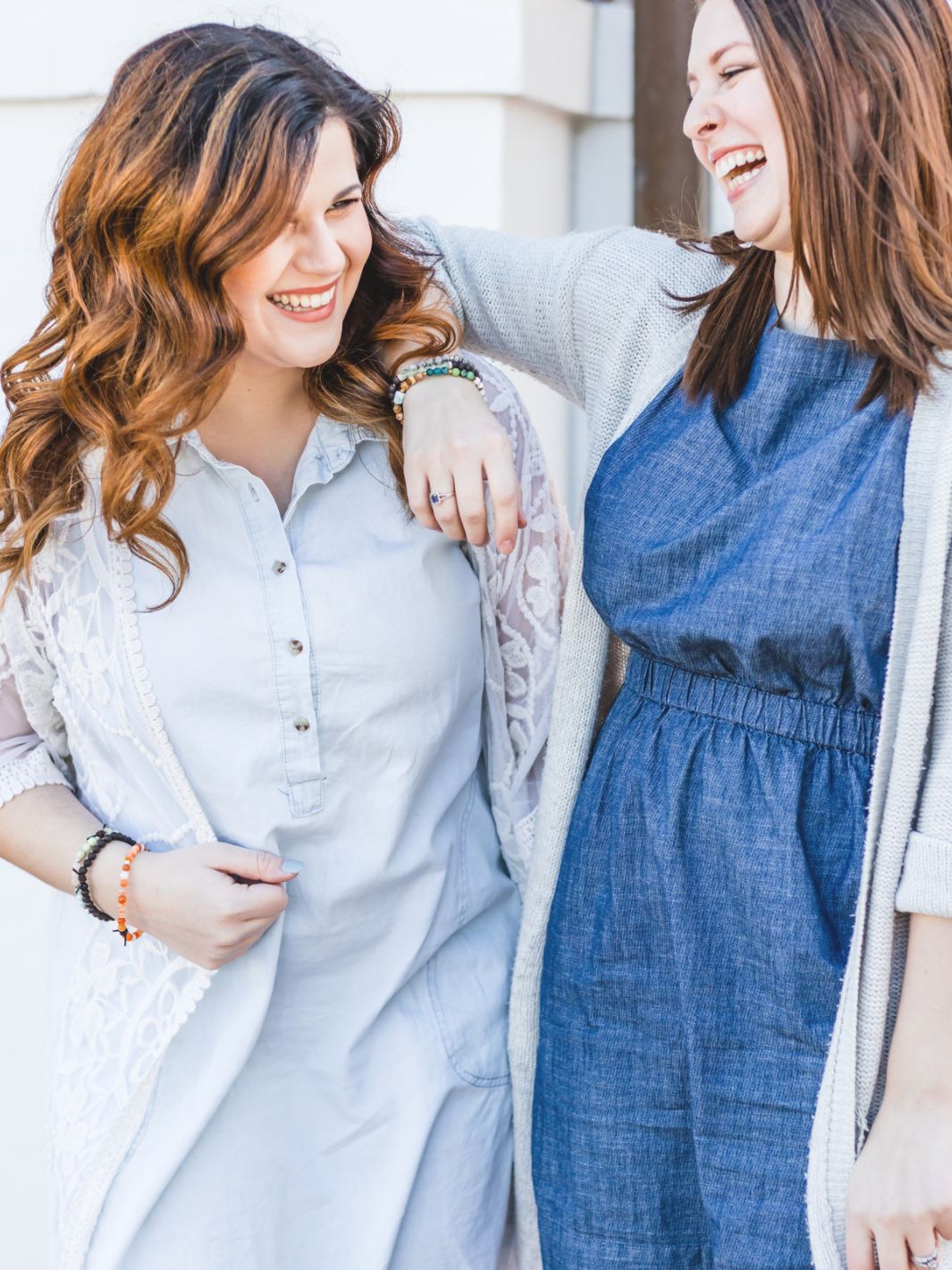 two women laughing with bracelets on