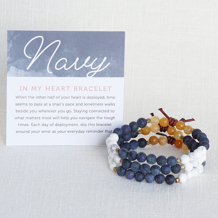 In My Heart Navy Bracelet with Meaning Card - When the other half of your heart is deployed, time seems to pass at a snail’s pace and loneliness walks beside you wherever you go. Staying connected to what matters most will help you navigate the tough times. Each day of deployment, slip this bracelet around your wrist as your everyday reminder that your hero is always in your heart even though there are miles between you.